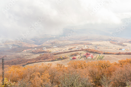 Village in the valley through the fog