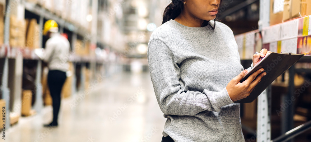 Portrait african american engineer woman shipping order detail on tablet check goods and supplies on shelves with goods inventory in factory warehouse.logistic industry and business export