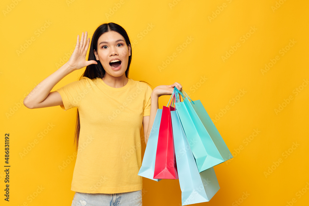 pretty brunette woman with packages in hands shopping isolated background unaltered pretty brunette woman with packages in hands shopping isolated background unaltered