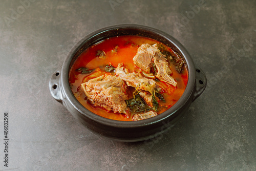 Gamjatang, Korean style Pork Back-bone Stew : A thick soup made of pig backbones, potato, green cabbage leaves (ugeoji), crushed perilla seeds, perilla leaves, spring onions, and garlic. A spicy dish 