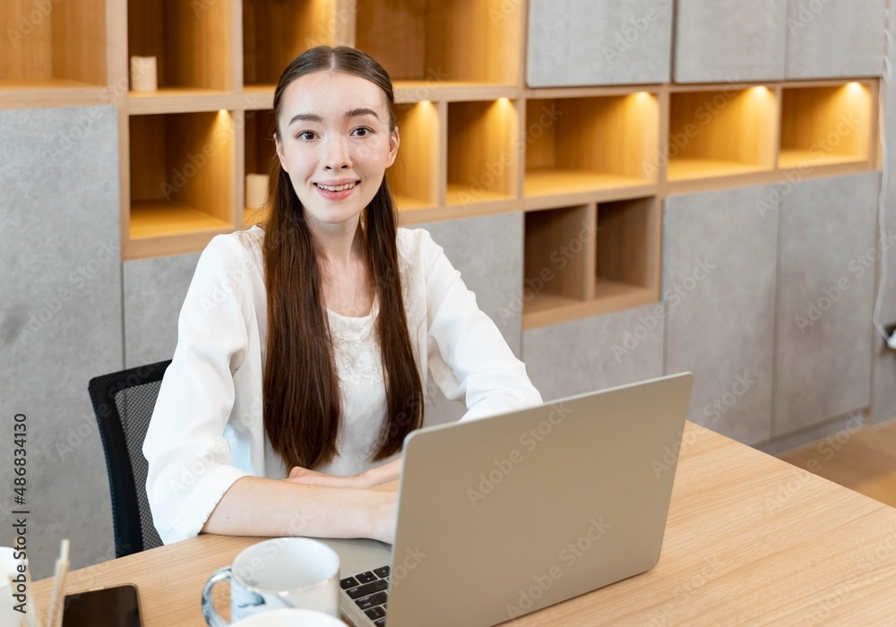 Beautiful caucasian woman working online from home as of social distancing policy in the business home office during new normal change lifestyle