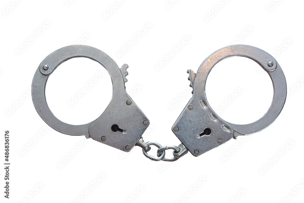 Metal handcuffs on a white isolated background Metal handcuffs on a white isolated background