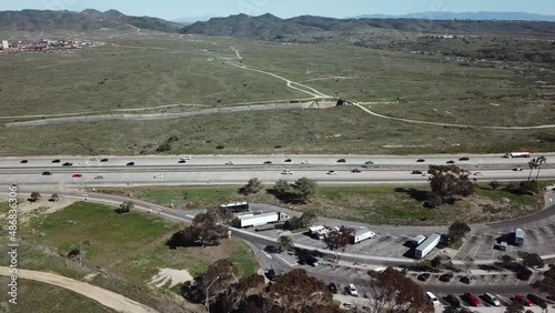 Descending aerial shot of resting area by interstate highway