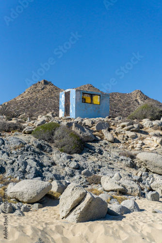 old tiny blue house in the mountains