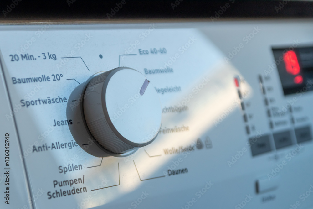 Detail view of washing machine control panel with contemporary thermostat and program selection to switch between different programs for laundry cleaning in modern household for housekeepers hygiene
