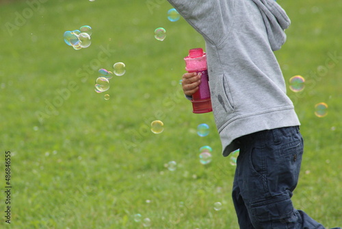 child blowing bubbles