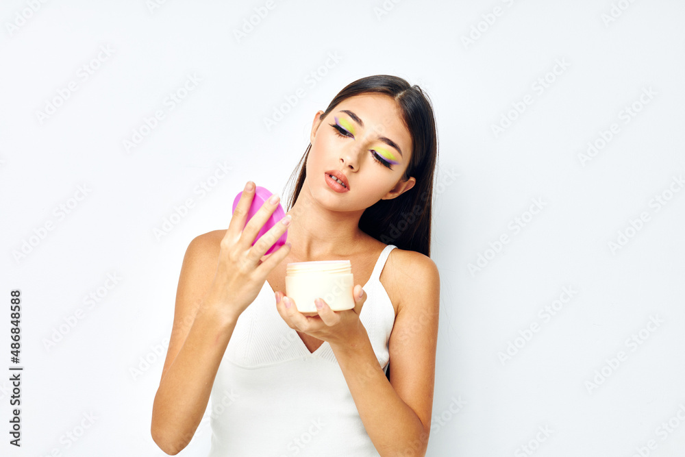 portrait pretty woman in a white jersey jar with cosmetics studio model unaltered portrait pretty woman in a white jersey jar with cosmetics studio model unaltered