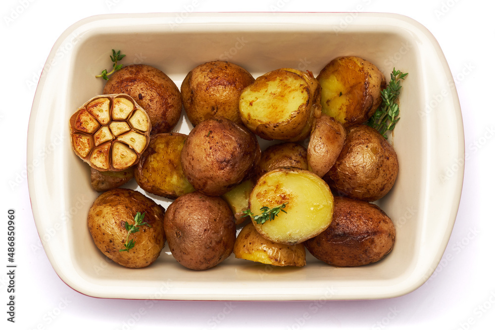 Baked potato in baking dish isolated on white background Baked potato in baking dish isolated on white background