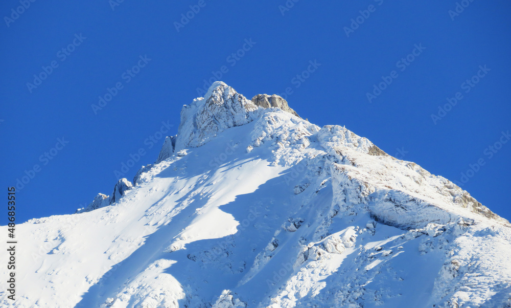 Obraz premium Winter ambience and beautiful idyllic atmosphere on the steep alpine rocky peak Stooss or Stoss (2112 m.a.s.l.) and the mountain Alpstein - Appenzell Alps massif - Switzerland (Schweiz)