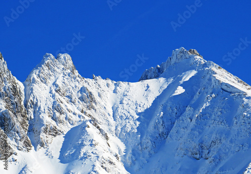 Winter ambience and beautiful idyllic atmosphere on the steep alpine rocky peak Stooss or Stoss (2112 m.a.s.l.) and the mountain Alpstein - Appenzell Alps massif - Switzerland (Schweiz) photo