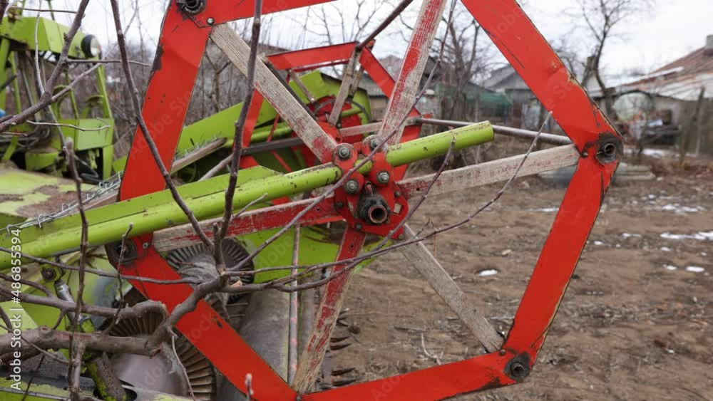 Close Up Of Combine Harvester Reel Attached To An Agricultural Tractor At The Farm. Close Up Of Combine Harvester Reel Attached To An Agricultural Tractor At The Farm.