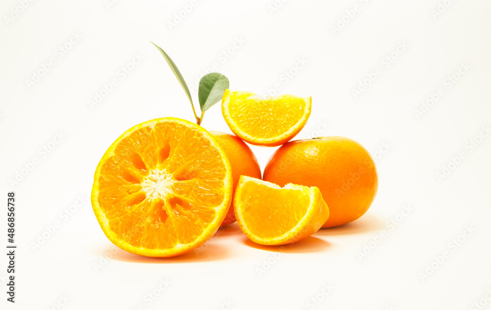 Group of oranges and leaves. Fresh-looking yellow fruit isolated on a white background. Fruits with vitamins and good health focus on specific points. Advertising concept and healthy, space for text Group of oranges and leaves. Fresh-looking yellow fruit isolated on a white background. Fruits with vitamins and good health focus on specific points. Advertising concept and healthy, space for text
