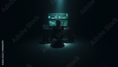 Cyberspy in an anonymous mask typing on the keyboard and attacking system data on a computer in the darkness during a cybercrime at night