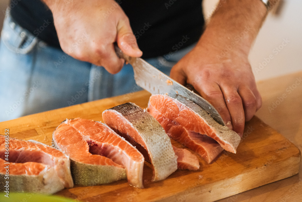 carving salmon with a large knife. Image Processing