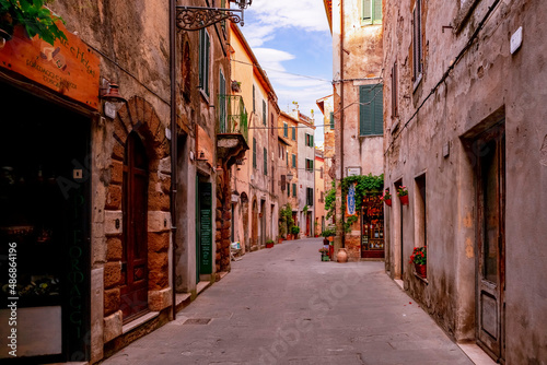 Narrow street with historic medieval houses in Pitigliano Tuscany