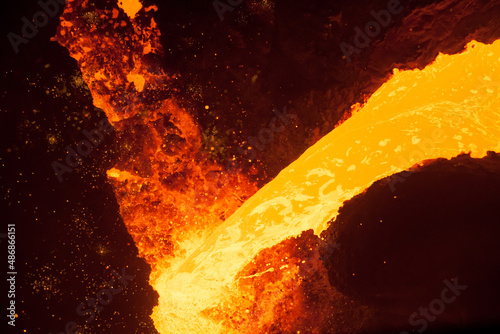 Jet of molten metal from pouring ladle.