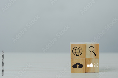 Wooden cubes with WEB 3.0 icon symbol on background and copy space.Business concepts.