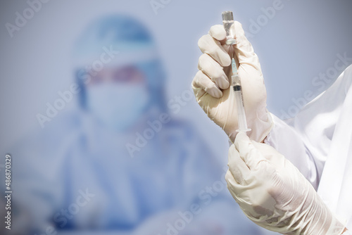 Doctor's hand holding a syringe, Concept fight against virus covid-19 coronavirus