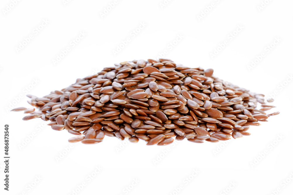 Obraz premium Flax seeds isolated on white background. Heap of flax seeds isolated on white background. Flax seeds isolated on white background. Dry flax seeds.