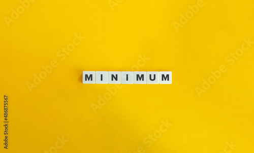 Minimum Word on Letter tiles on bright orange background. Minimal aesthetics. photo