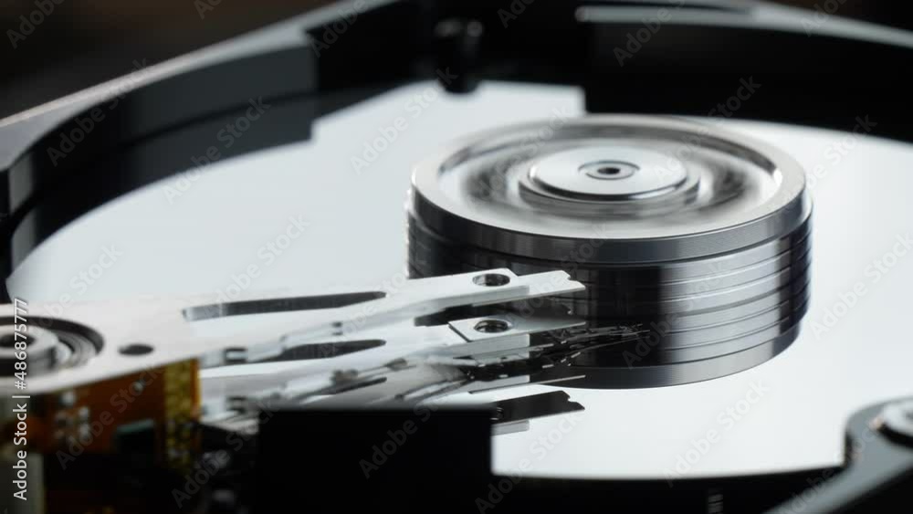 Working hard disk drive with a spinning platter. Starting and stopping HDD platter Working hard disk drive with a spinning platter. Starting and stopping HDD platter