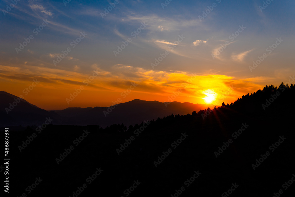 dark and moody dramatic sunset sky mountains silhouette