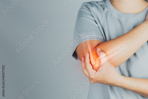 Health concept, person with elbow pain, woman holding hands on elbow with pain, virtual bone image on elbow