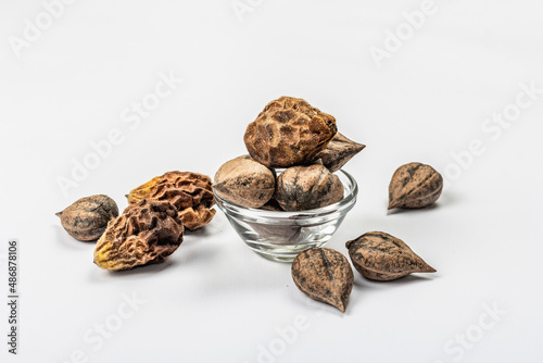 Ripe Juglans cordiformis Maxim or heart-shaped walnut isolated on white background photo