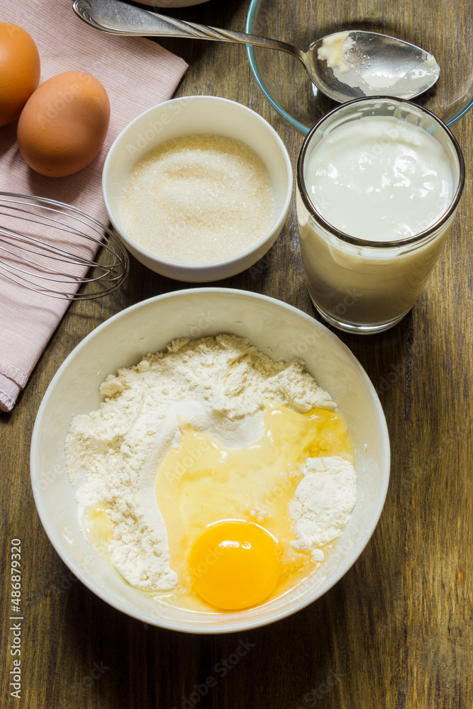 Dough for cooking pancakes on kefir. Eggs, flour, a glass of kefir, sugar, salt. Country style. Dough for cooking pancakes on kefir. Eggs, flour, a glass of kefir, sugar, salt. Country style.