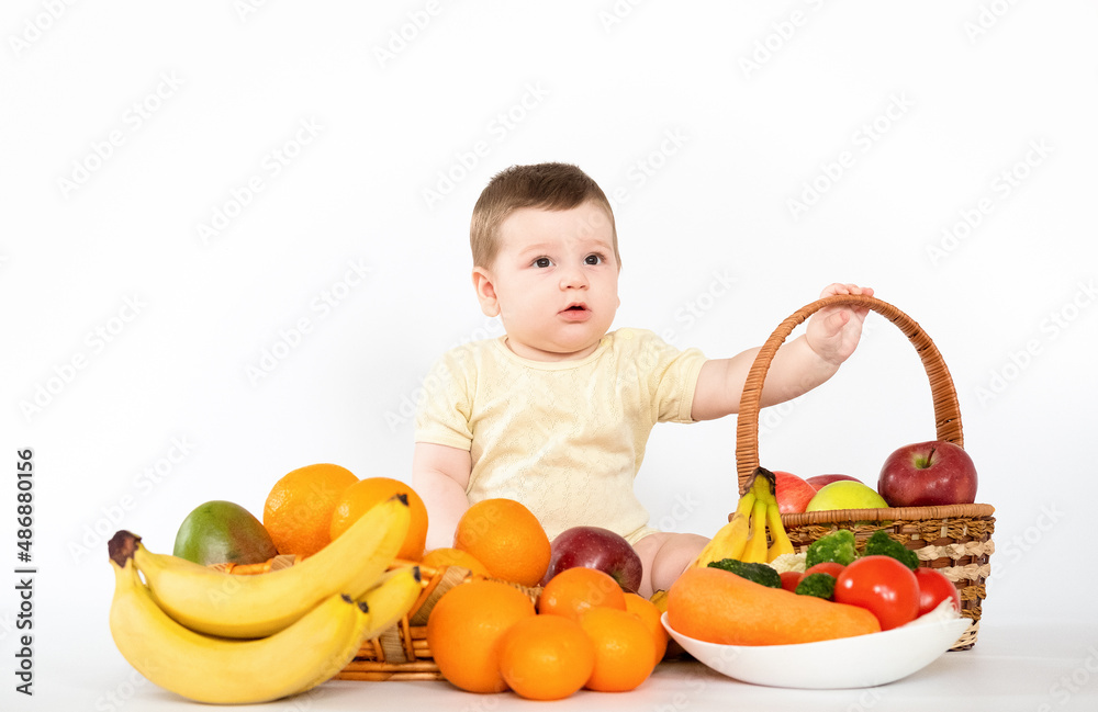 Cute baby boy sitting with fruits and vegetables isolated on white background healthy food feed baby Cute baby boy sitting with fruits and vegetables isolated on white background healthy food feed baby