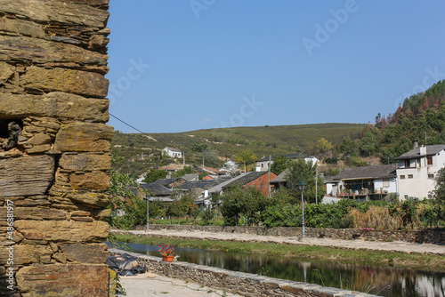 Stone wall framing the river in Rihonor de Castilla, Spain photo