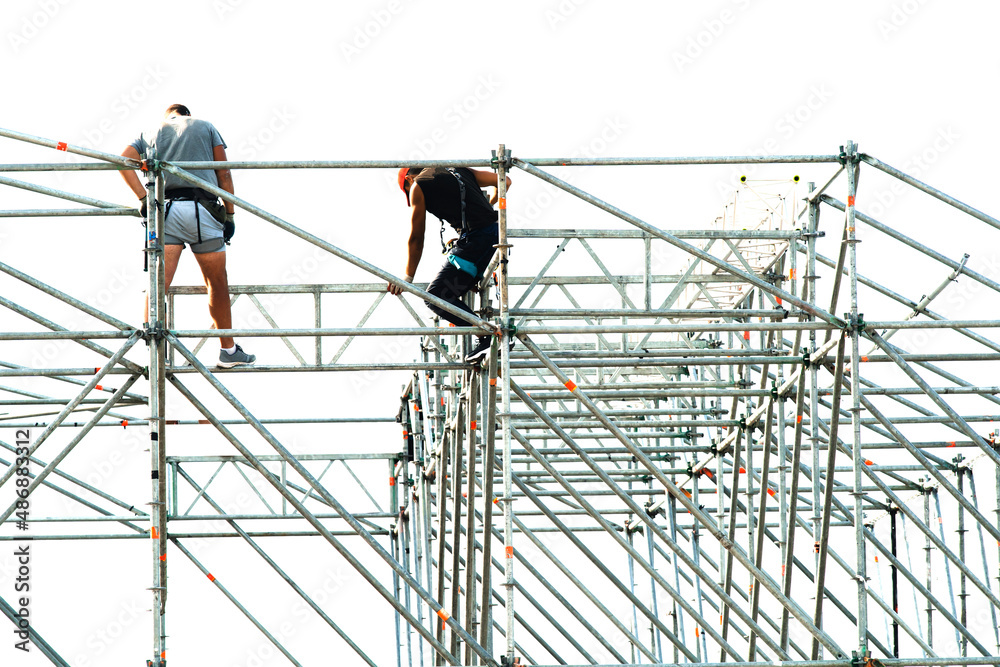 Setting up a mobile scene. Construction of a metal structure for a mass event. The fitters are assembling the details of a large structure. unrecognizable person