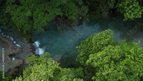 Aerial top down view waterfall river in tropical jungle green rainforest in Colombia photo