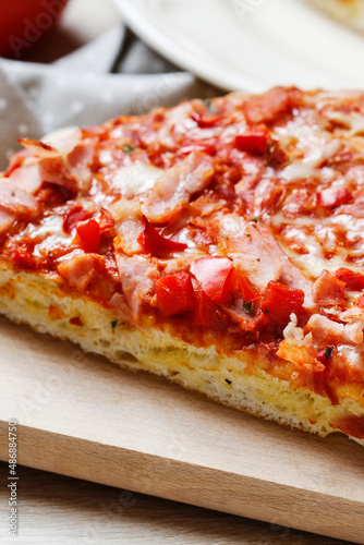 Real homemade italian pizza with tomatoes, ham and cheese.