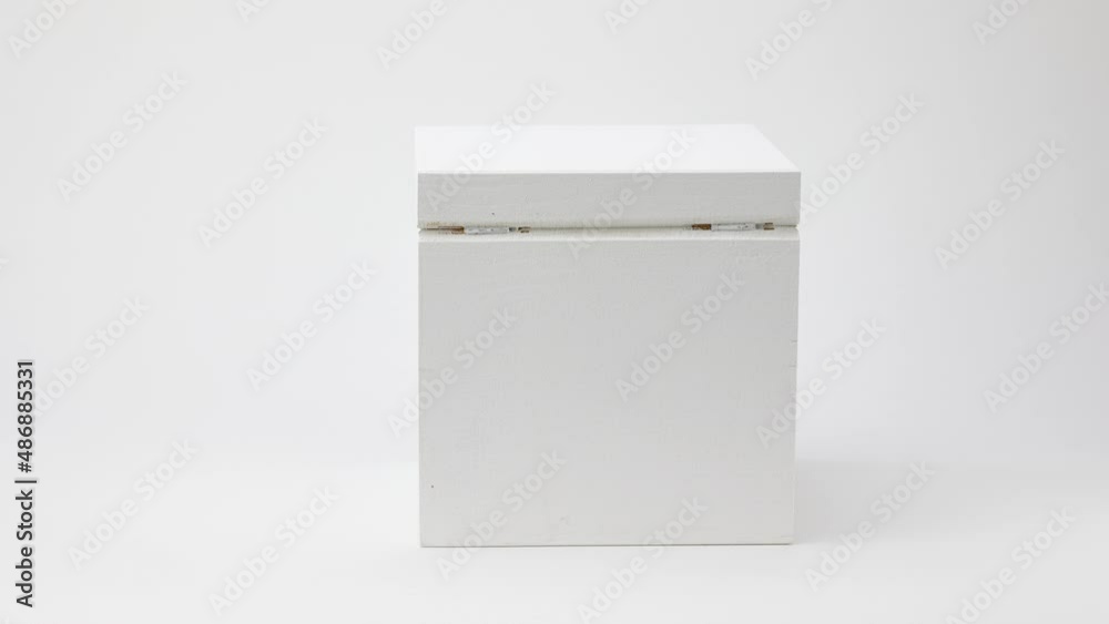 rotating abstract white painted wooden box on white background, stop motion rotating abstract white painted wooden box on white background, stop motion