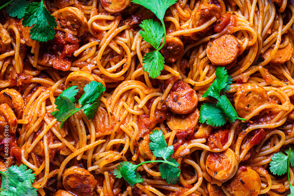 Baked spaghetti pasta with sausages in tomato sauce in oven dish. Baked spaghetti pasta with sausages in tomato sauce in oven dish.