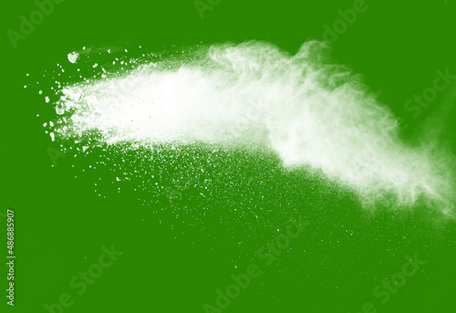 Explosion of white powder isolated on green background. Abstract colored background. holi festival.