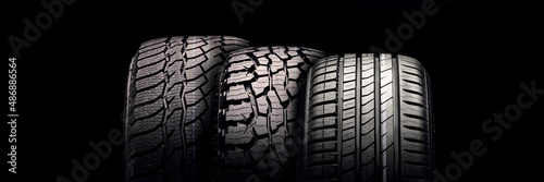 new mud tire for off-road cars SUV close-up tread on black background