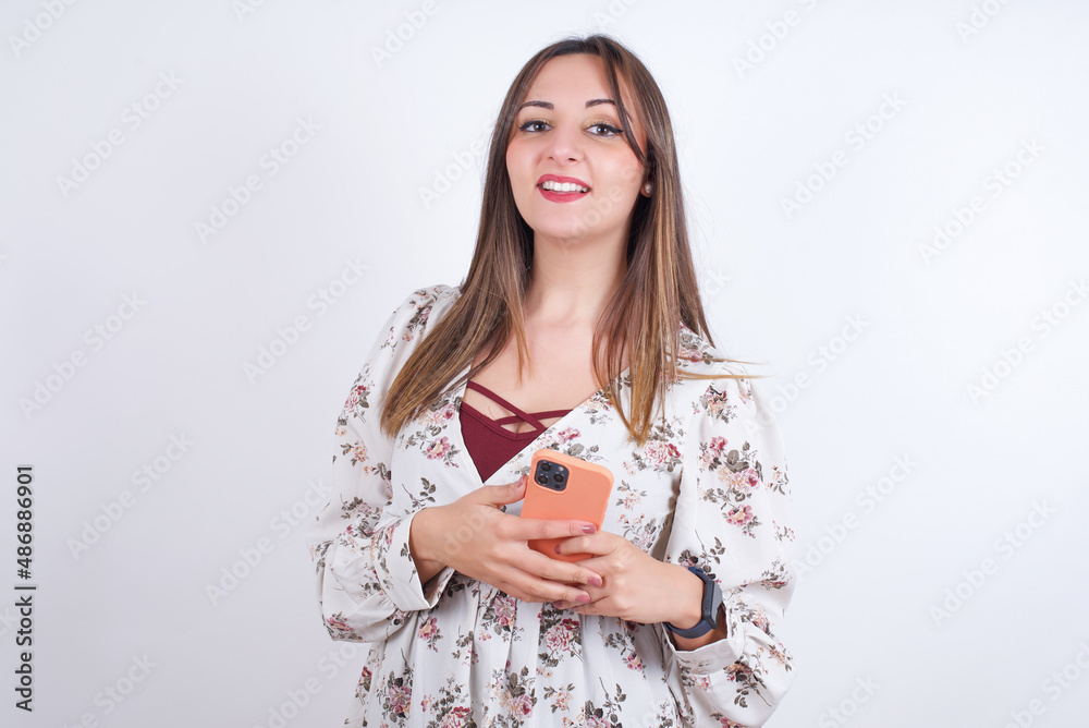 Smiling MODEL friendly and happily holding mobile phone taking selfie in mirror. Smiling MODEL friendly and happily holding mobile phone taking selfie in mirror.