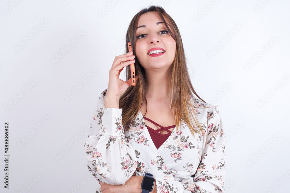 Portrait of a smiling MODEL talking on mobile phone. Business, confidence and communication concept. Portrait of a smiling MODEL talking on mobile phone. Business, confidence and communication concept.