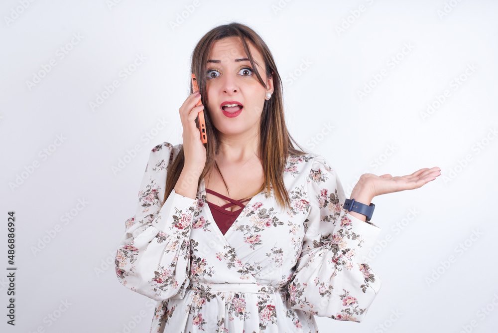 MODEL talking on the phone stressed with hand on face, shocked with shame and surprise face, angry and frustrated. Fear and upset for mistake. MODEL talking on the phone stressed with hand on face, shocked with shame and surprise face, angry and frustrated. Fear and upset for mistake.