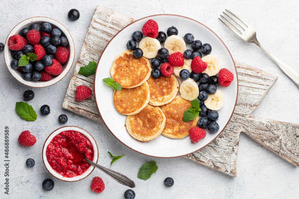 Keto diet pancakes made or almond flour, served with berries. Keto diet pancakes made or almond flour, served with berries.
