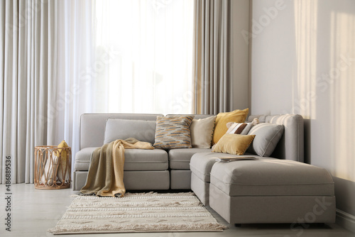 Living room interior with large grey sofa photo