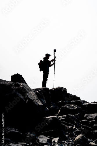 silhouette black man survey and civil engineer stand on ground working in a land building site over Blurred construction worker on construction site. examination, inspection, survey