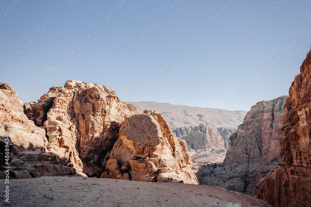 The ancient city of Petra in Jordan. Red sandstone mountains on a clear day. Caves in the rock. Landscape. Colorful photos.