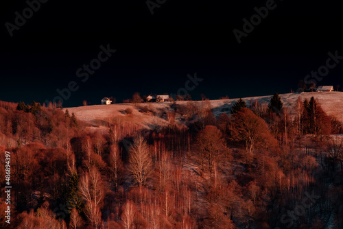 Idylic sunset light over Bucegi Mountains, Romania. Fundata village landscape photo