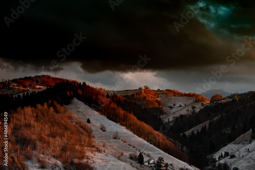Idylic sunset light over Bucegi Mountains, Romania. Fundata village landscape