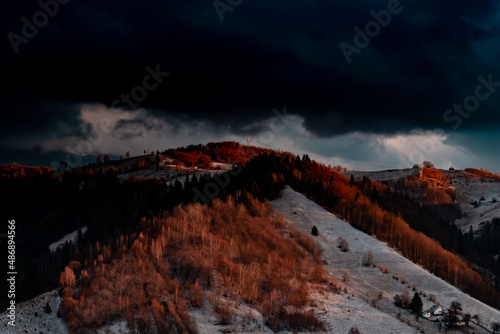 Idylic sunset light over Bucegi Mountains, Romania. Fundata village landscape