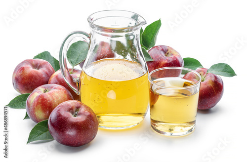 Glass and carafe of fresh apple juice and organic apples isolated on white background.