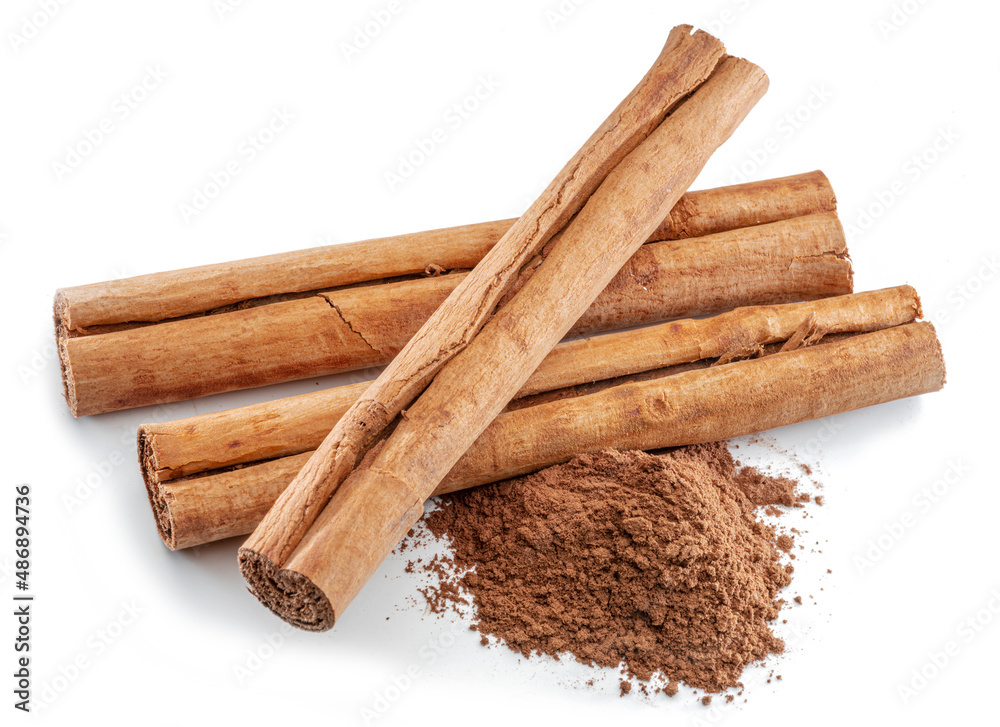 Cinnamon dried bark strips and cinnamon powder, sweet-smelling brown substance used in cooking, isolated on white background. Cinnamon dried bark strips and cinnamon powder, sweet-smelling brown substance used in cooking, isolated on white background.